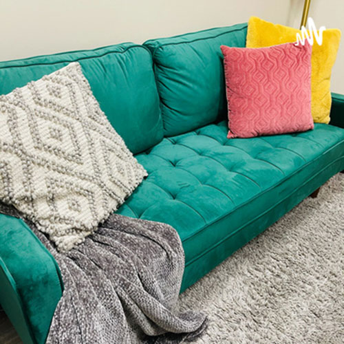 Cute aqua couch with trendy pillows
