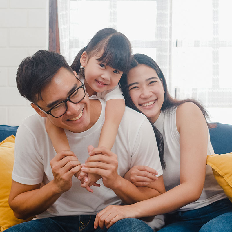 Parent Child Interaction Therapy at Mirjam Quinn & Associates, smiling family hugging each other on a couch