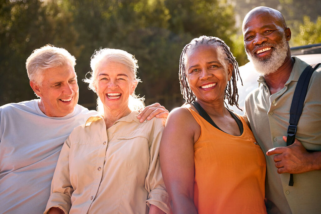 How to cultivate a sense of belonging graphic, group of seniors with different backgrounds together smiling outside