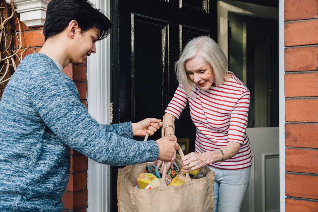 Helping Others, young man delivering groceries to an elderly neighbor