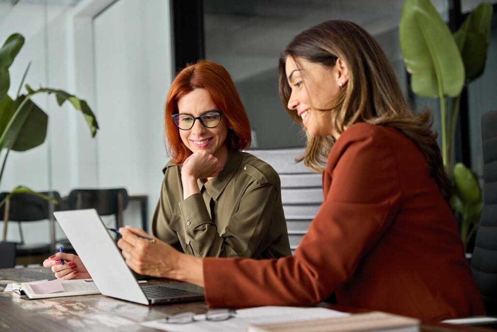 Speaking up with Courage, two middle-aged women talking in an office