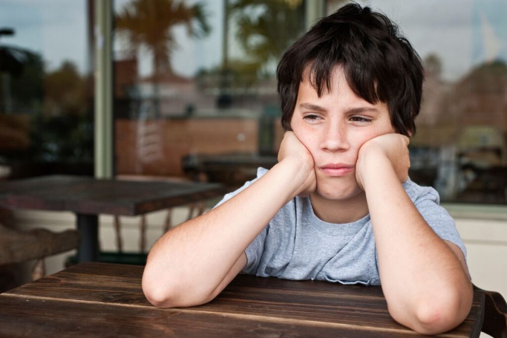 Supporting Growth Without Pushing Too Hard, young boy frustrated with head in hands